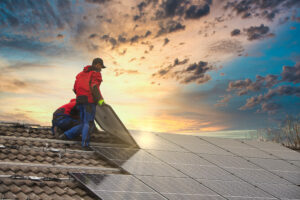 solar installers on a roof in the sunset